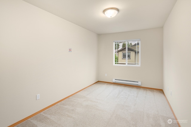 spare room with a baseboard radiator and carpet floors