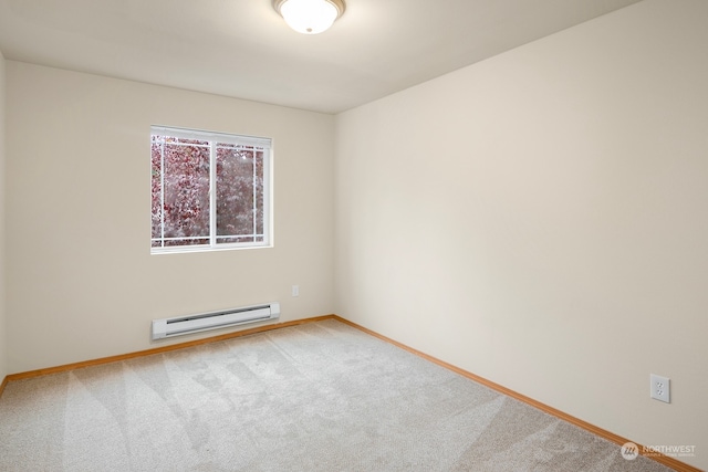 carpeted spare room featuring a baseboard heating unit