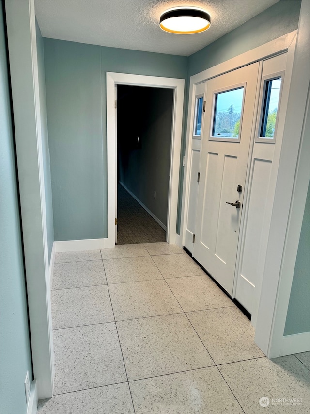 entryway with a textured ceiling