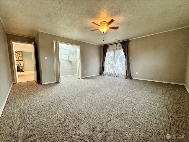 unfurnished room with ceiling fan, carpet flooring, and a textured ceiling