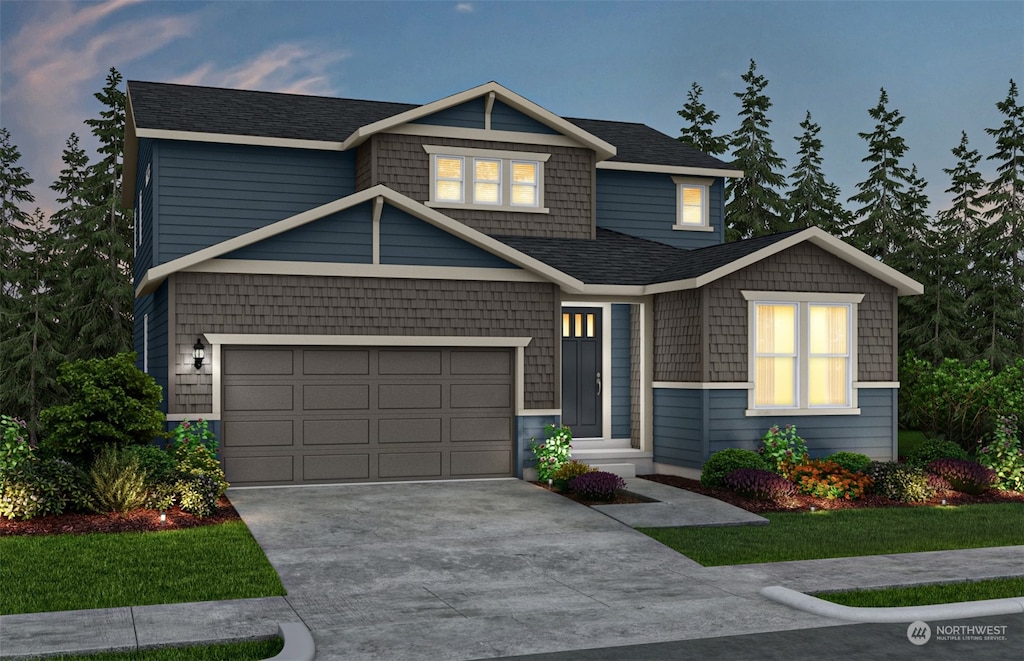 craftsman-style house featuring a yard and a garage