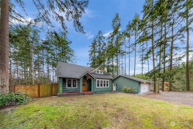 view of front of home with a front lawn, an outdoor structure, and a garage