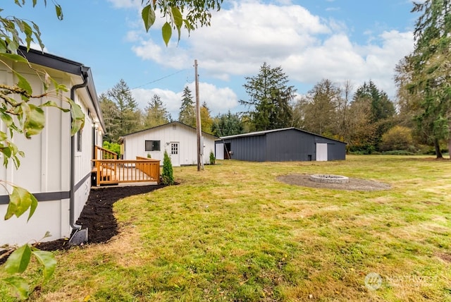 4249 88th Ave SW, Olympia, WA 98512 - view of yard with a wooden deck and a fire pit