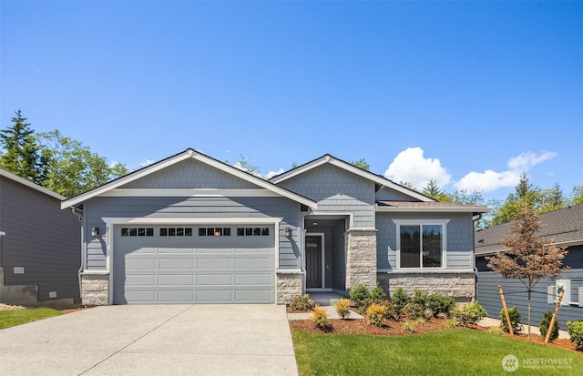 23557 Arbors Terrace Rd NE Unit 32, Kingston, WA 98346 - craftsman-style house featuring stone siding, concrete driveway, an attached garage, and a front yard