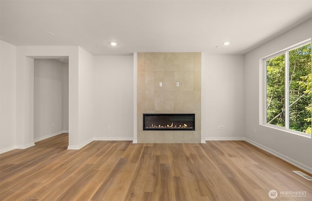 23557 Arbors Terrace Rd NE Unit 32, Kingston, WA 98346 - unfurnished living room with a tile fireplace, wood finished floors, baseboards, and recessed lighting