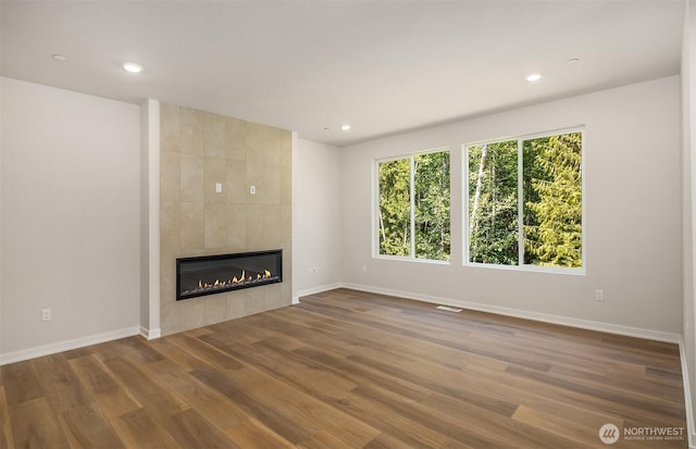 23557 Arbors Terrace Rd NE Unit 32, Kingston, WA 98346 - unfurnished living room with a tile fireplace, wood finished floors, baseboards, and recessed lighting