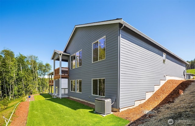 23557 Arbors Terrace Rd NE Unit 32, Kingston, WA 98346 - view of property exterior featuring a balcony, central AC, and a yard