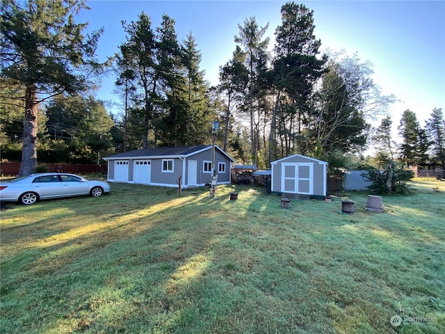 view of yard featuring a garage and a storage unit