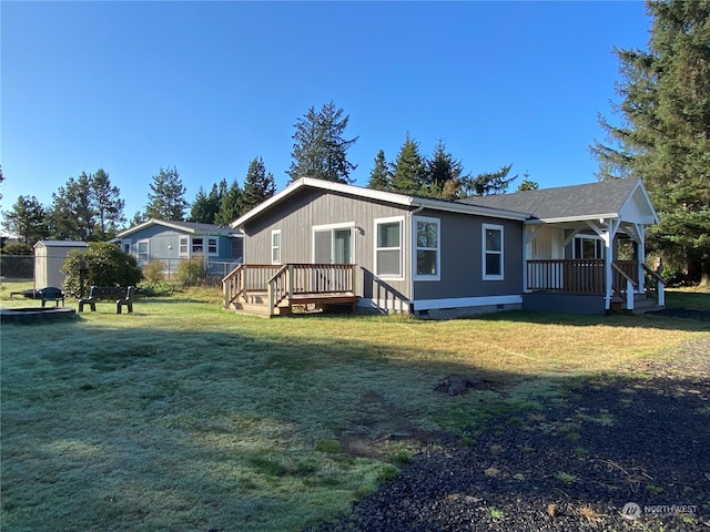 rear view of house with a yard