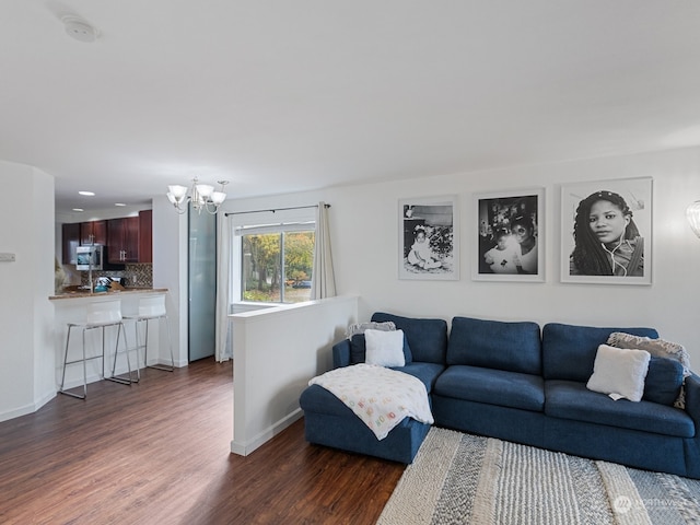 living room featuring dark wood-type flooring and a chandelier