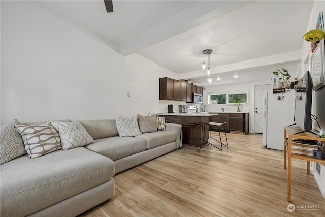 living room with beam ceiling and light hardwood / wood-style floors