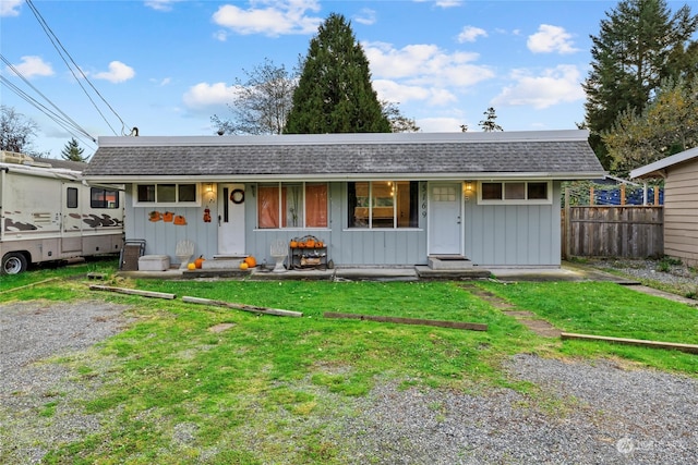 ranch-style home with a front yard and covered porch