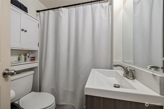 bathroom featuring toilet, a shower with curtain, and vanity