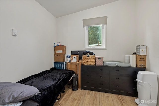 bedroom with light hardwood / wood-style flooring and vaulted ceiling