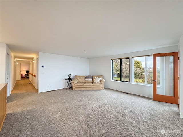 unfurnished living room featuring light carpet