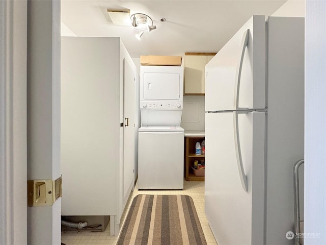 washroom with stacked washer and clothes dryer and light tile patterned flooring