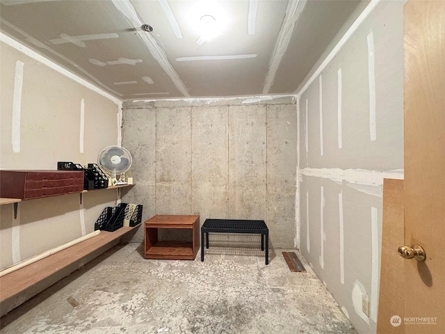 sitting room featuring concrete flooring