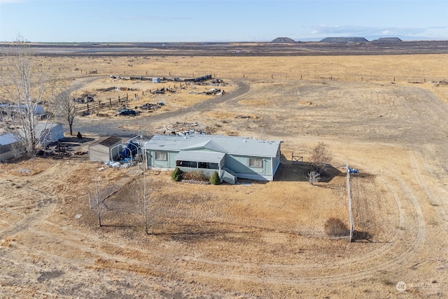 drone / aerial view with a mountain view and a rural view