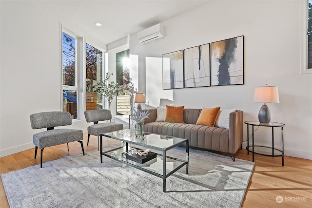 living room with hardwood / wood-style floors and a wall mounted air conditioner