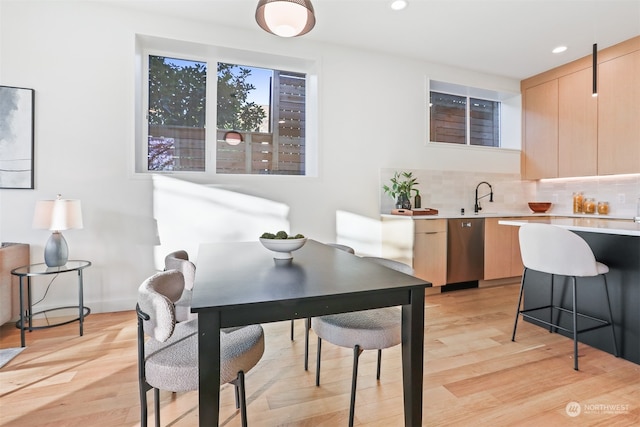 dining area featuring sink and light hardwood / wood-style floors