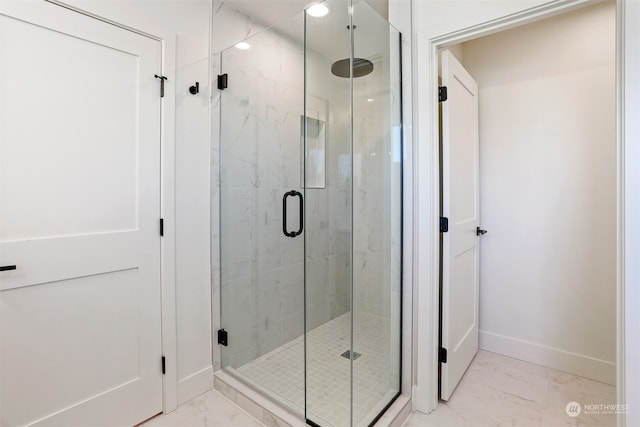 bathroom featuring a shower with door