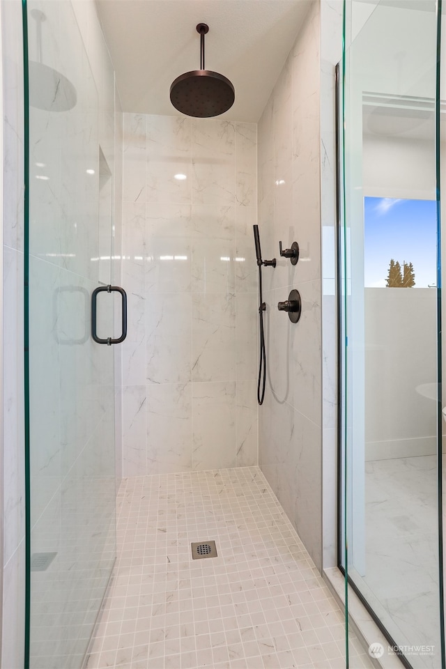 bathroom with a shower with shower door