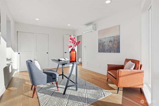 office space featuring a wall mounted AC and light wood-type flooring