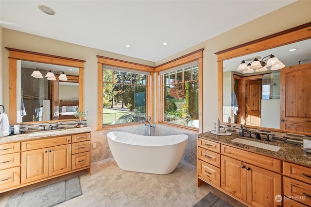1114 S Wells, East Wenatchee, WA 98802 - full bathroom with tile walls, a soaking tub, two vanities, a wainscoted wall, and recessed lighting