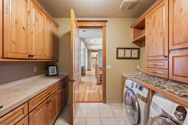 1114 S Wells, East Wenatchee, WA 98802 - laundry room with separate washer and dryer, cabinet space, light tile patterned flooring, and baseboards