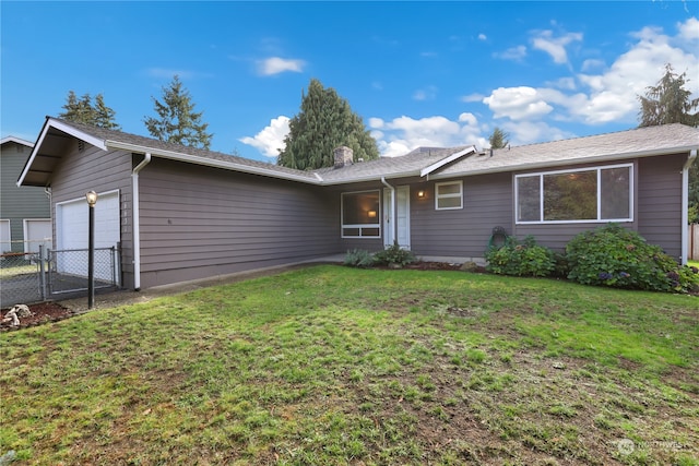 single story home featuring a garage and a front yard