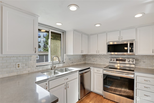 kitchen with white cabinetry, sink, and stainless steel appliances