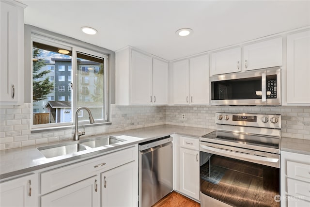 kitchen featuring white cabinetry, appliances with stainless steel finishes, and sink