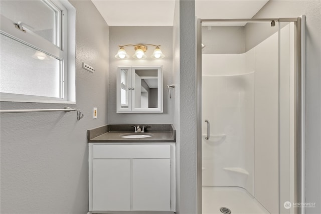 bathroom with a shower and vanity