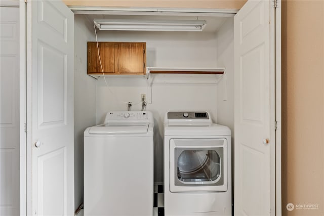 laundry area featuring washing machine and clothes dryer