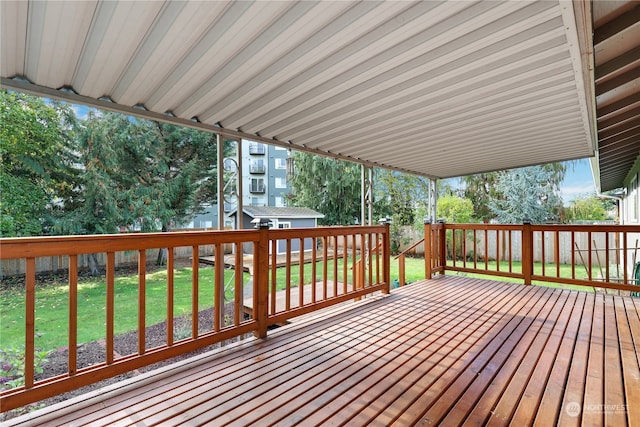 wooden terrace featuring a lawn