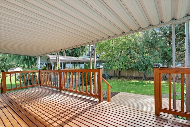 wooden terrace with a lawn