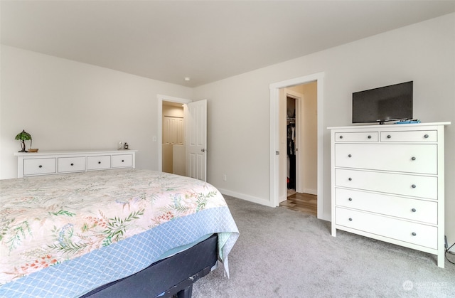 carpeted bedroom with a spacious closet