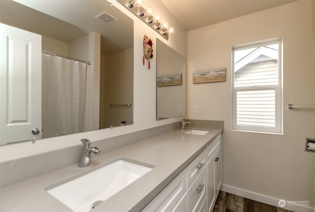 bathroom featuring vanity and hardwood / wood-style flooring