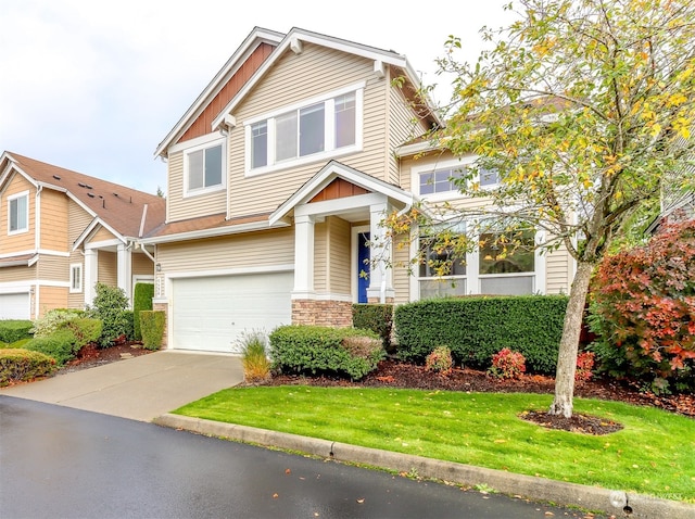 craftsman-style house featuring a front lawn and a garage