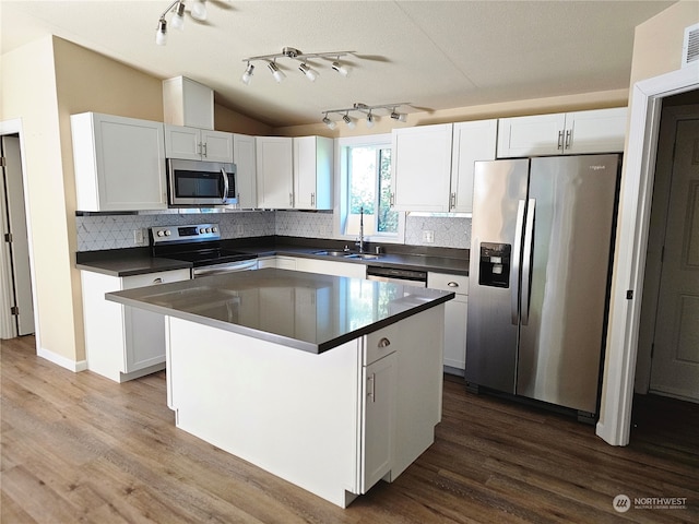 kitchen featuring a center island, white cabinets, stainless steel appliances, and sink