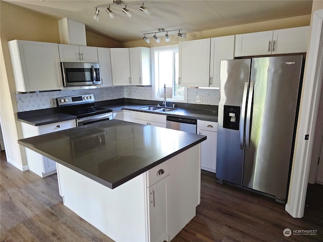 kitchen with stainless steel appliances, sink, dark hardwood / wood-style floors, and white cabinets