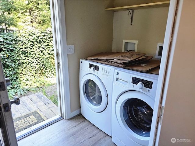 laundry room featuring washer and dryer and light hardwood / wood-style floors