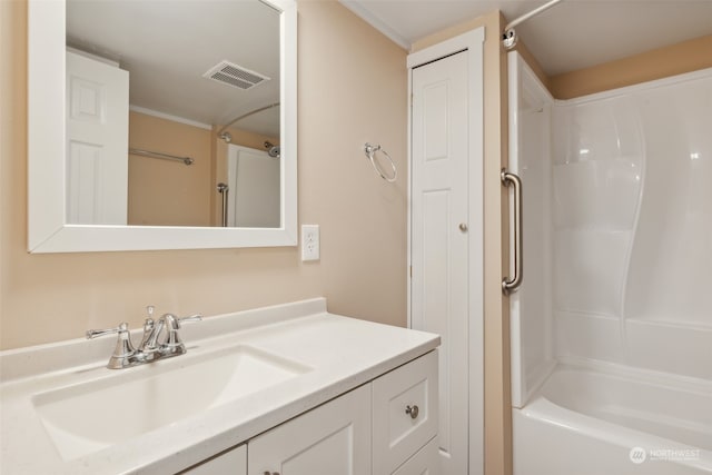 bathroom with vanity, ornamental molding, and shower / washtub combination