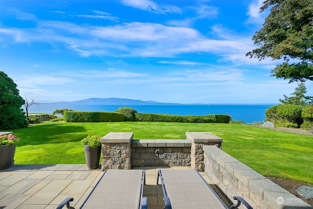 view of patio / terrace featuring a water and mountain view