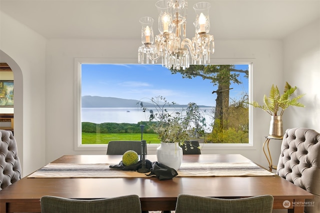 dining room with a chandelier and a mountain view