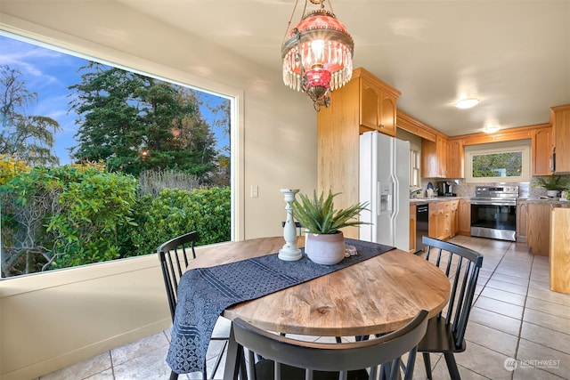 dining area featuring a notable chandelier and light tile patterned floors