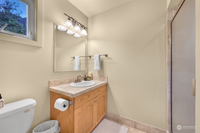 bathroom featuring vanity, toilet, and tile patterned floors