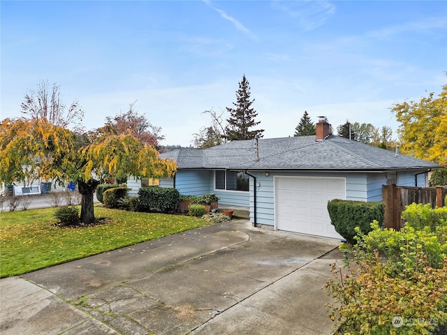 view of front of house with a front lawn and a garage