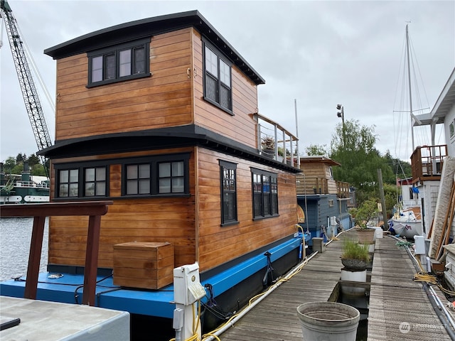 view of side of home featuring a boat dock