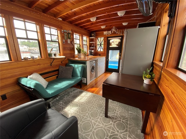 sitting room featuring beamed ceiling, washer / dryer, light hardwood / wood-style floors, and wooden ceiling